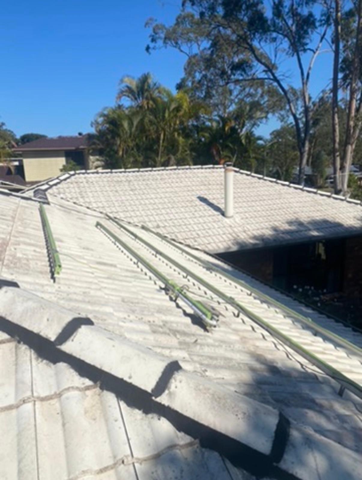 Faded concrete tile roof prior to professional roof painting and restoration