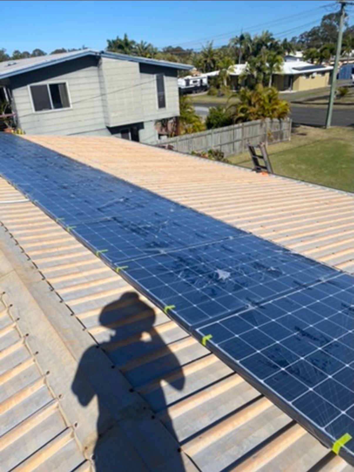 Metal roof with solar panels before cleaning and painting