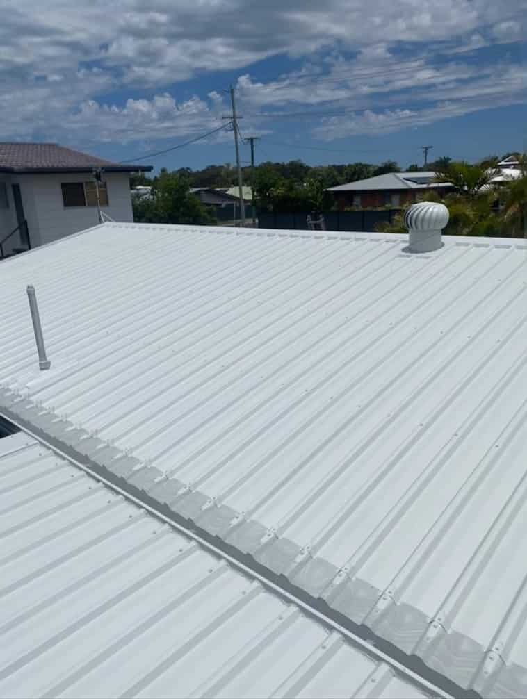 Freshly painted bright white metal roof following a complete roof restoration